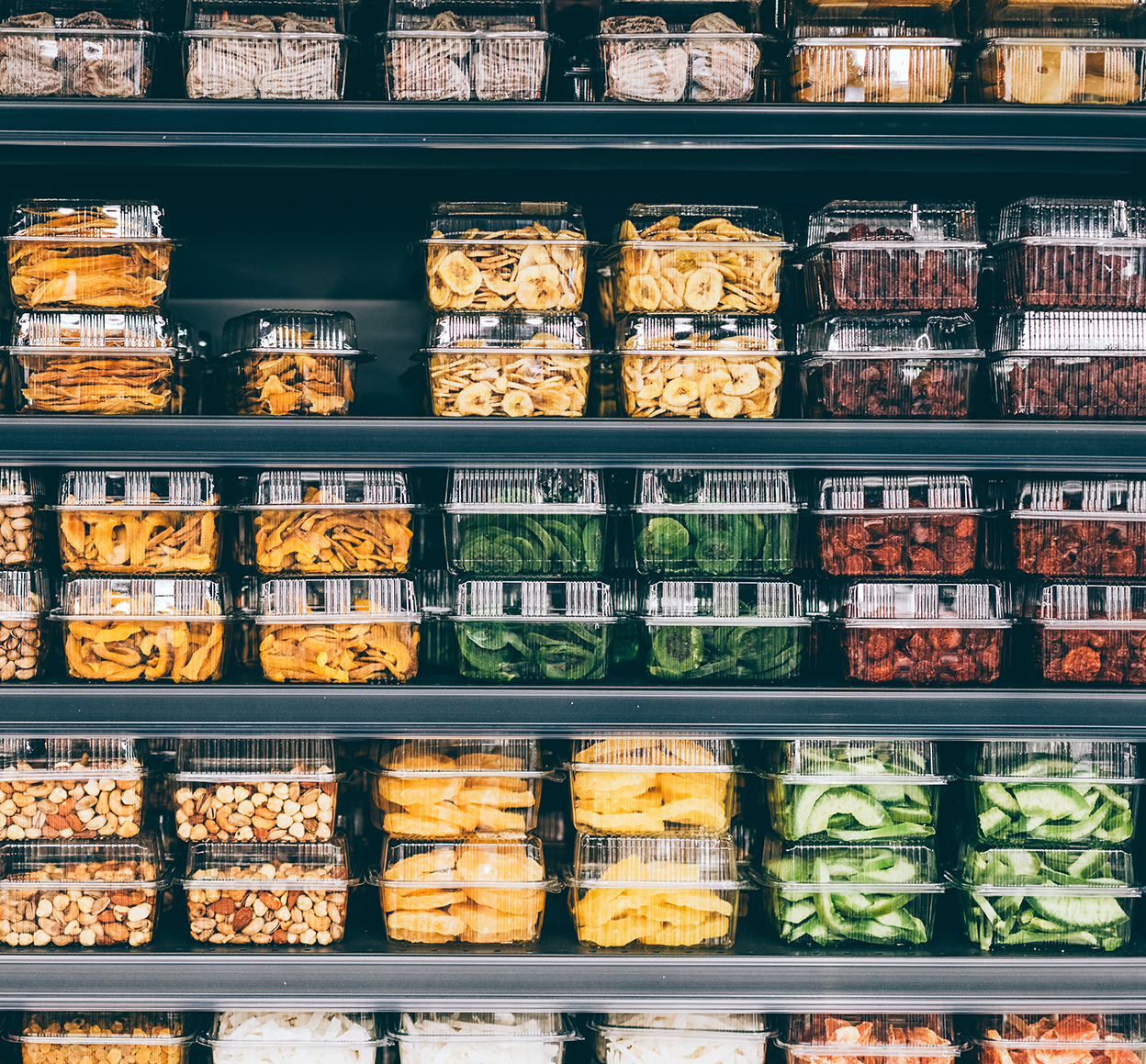 ot-quote-misc-products-on-shelf Store shelves with dried fruit, veggies, and nuts in a non-ecological packaging, non-branded. An image of plastic usage everywhere. Taking steps to a more sustainable lifestyle by utilizing reusable packaging and responsible business ideas.